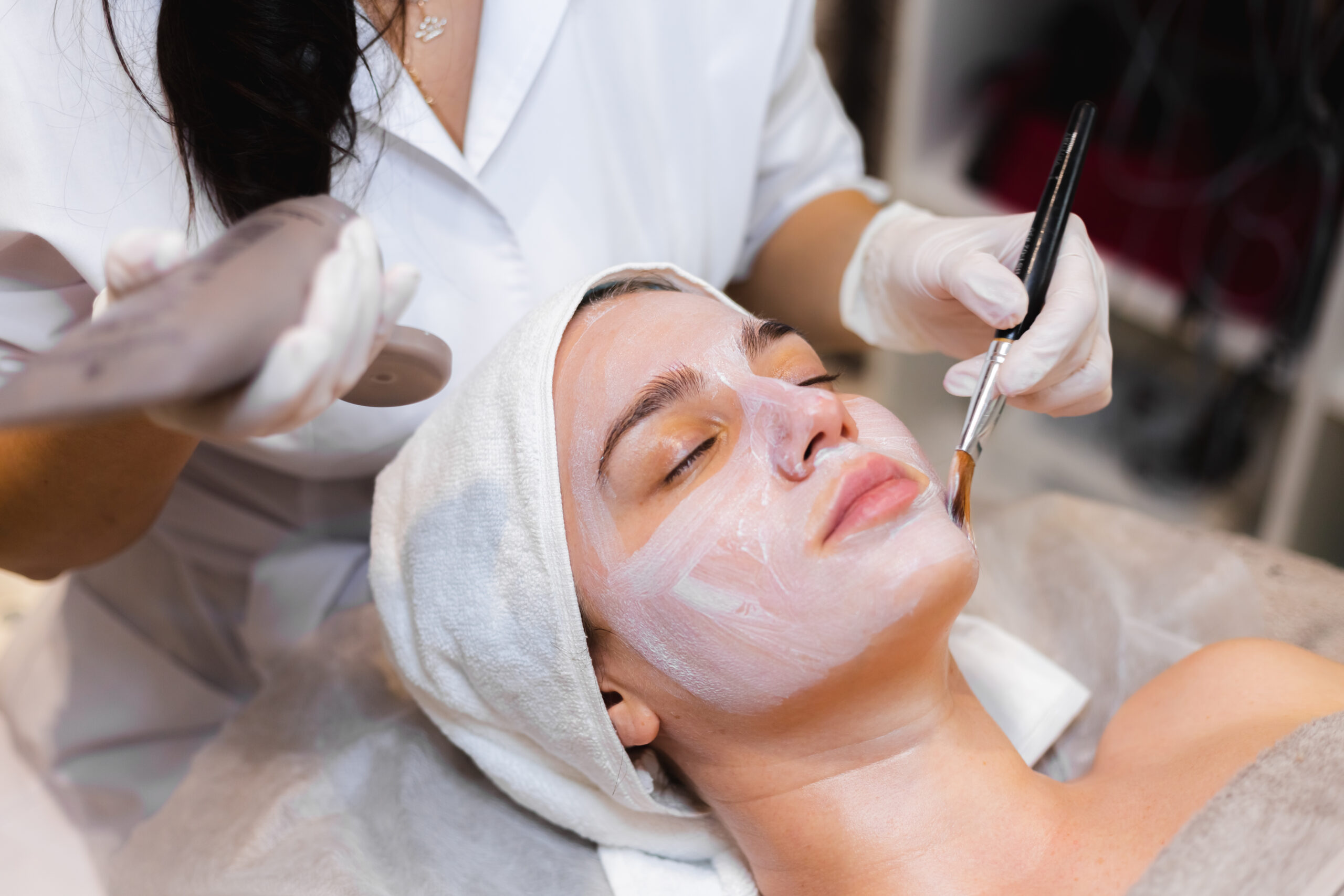 Home 3 Beautician With Brush Applies White Moisturizing Mask Face Young Girl Client Spa Beauty Salon